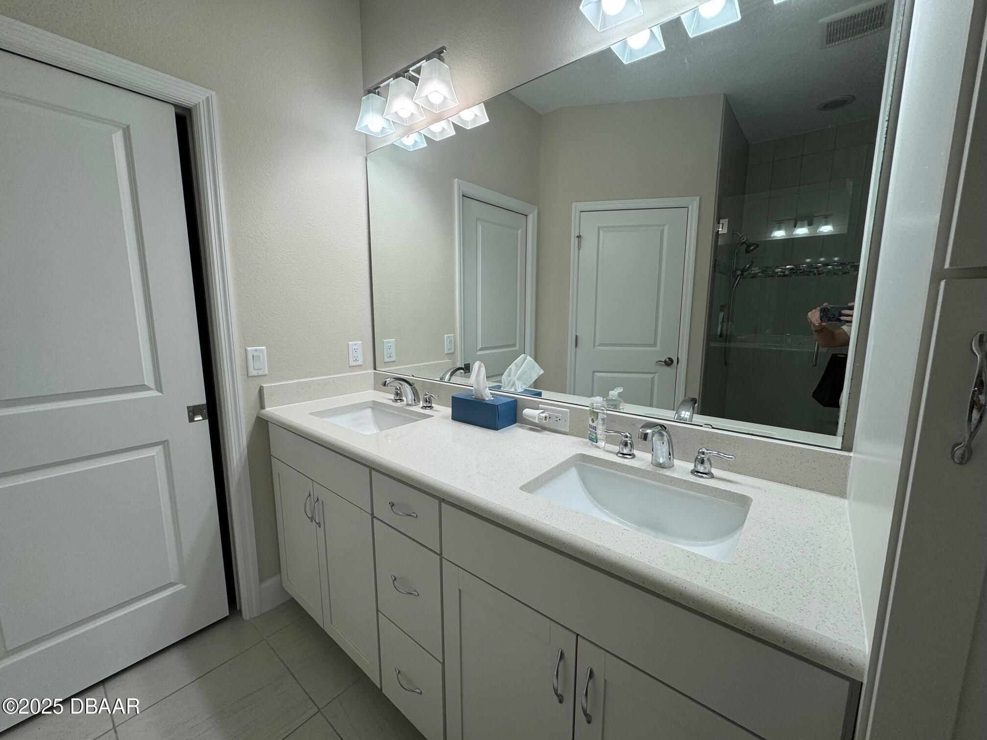 1016 Sea Shell Court Daytona Beach, FL 32124 - Photo 8 of 25 a bathroom with a sink double vanity and a mirror