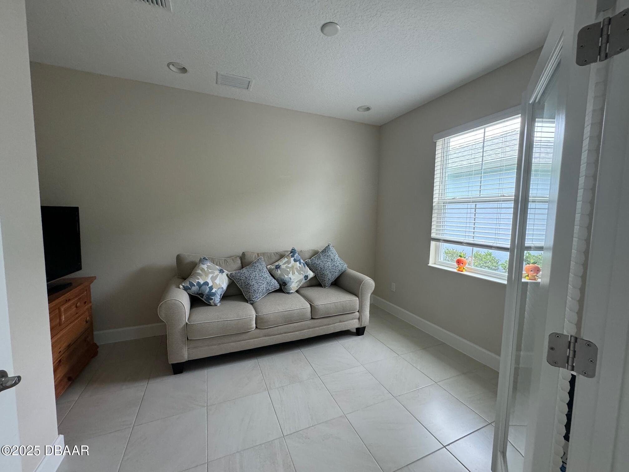 1016 Sea Shell Court Daytona Beach, FL 32124 - Photo 9 of 25 a living room with furniture and a flat screen tv
