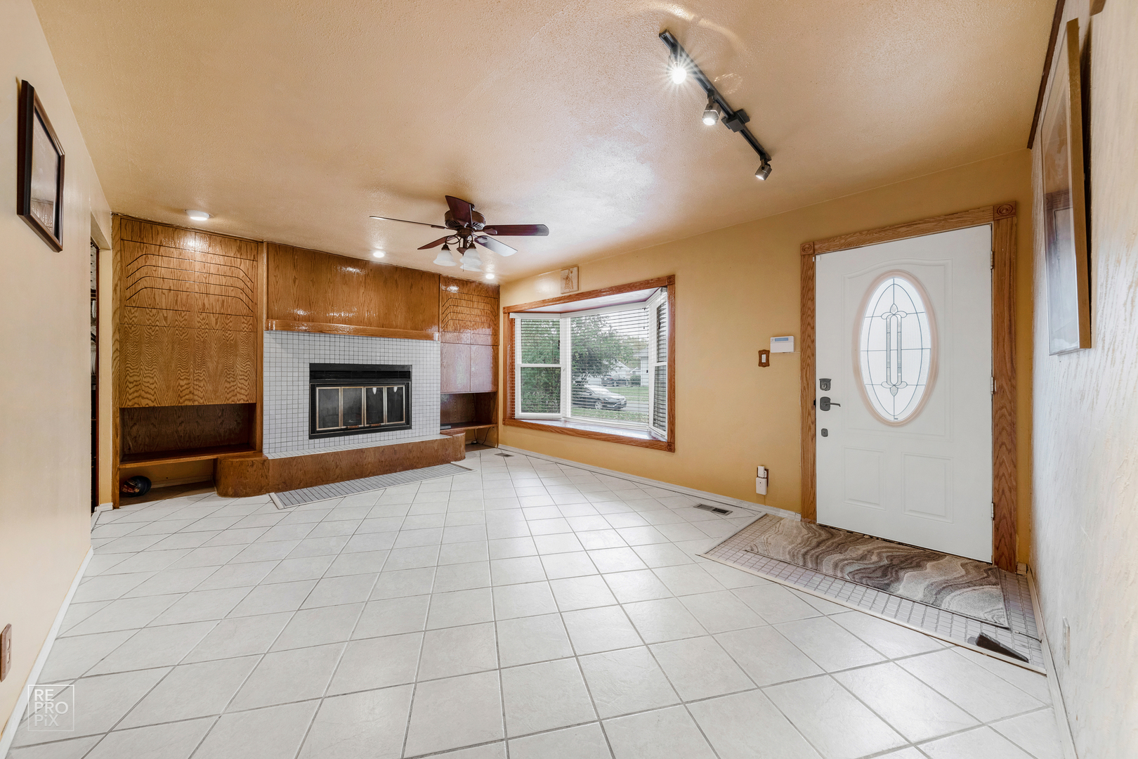 512 Audubon Road Streamwood, IL 60107 - Photo 2 of 10 a view of an empty room with a fireplace and a window