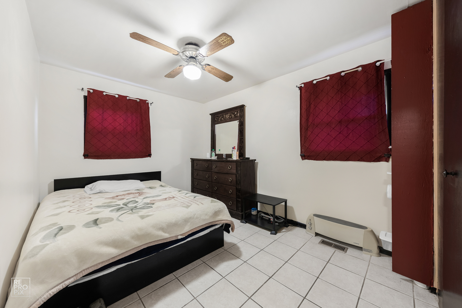 512 Audubon Road Streamwood, IL 60107 - Photo 7 of 10 a bedroom with a bed and a painting on the wall