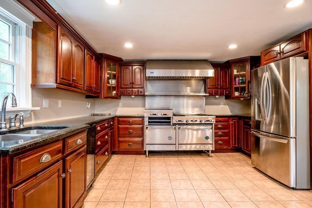 196 Middleton Road Boxford, MA 01921 - Photo 13 of 34 a kitchen with stainless steel appliances granite countertop a stove top oven a sink and a refrigerator