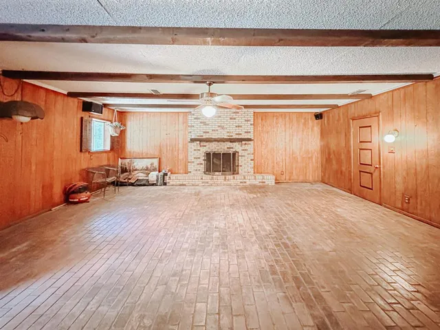 a view of empty room with a fireplace