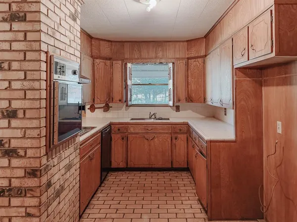 a kitchen with stainless steel appliances a cabinets and a counter top space