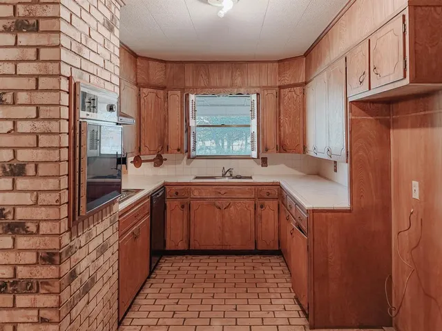 a kitchen with stainless steel appliances a cabinets and a counter top space