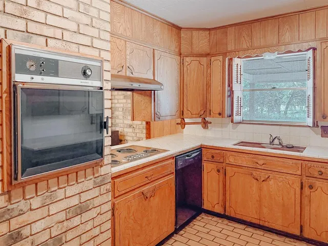 a view of kitchen with microwave and cabinets