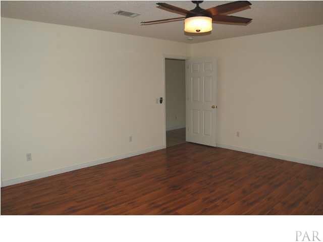 119 Gunwale Road Pensacola, FL 32507 - Photo 9 of 21 a room with a ceiling fan and wooden floor