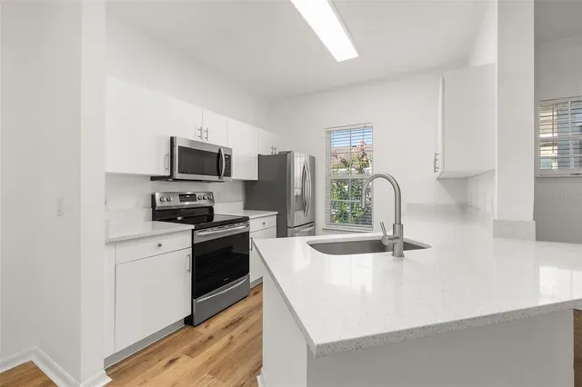 a kitchen with a refrigerator sink and stove