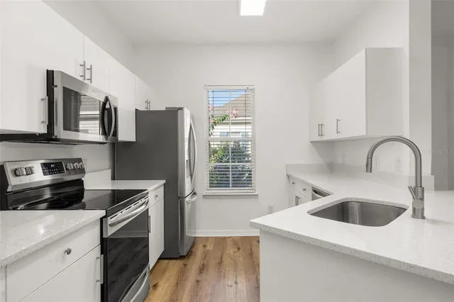 a kitchen with a sink cabinets and window