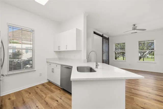 a kitchen with stainless steel appliances a refrigerator and a stove top oven