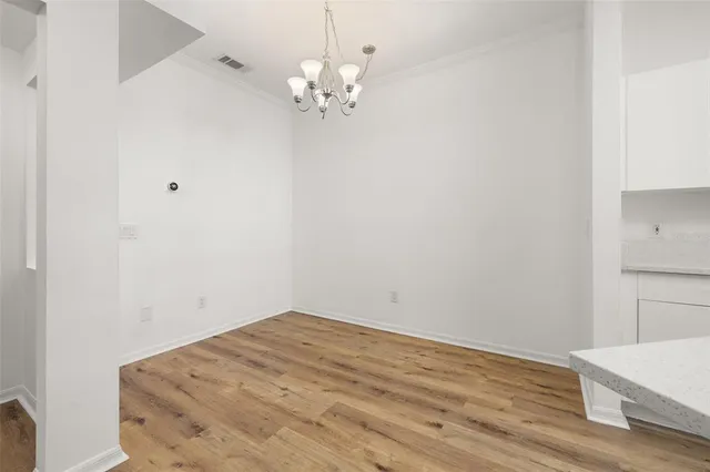 a view of a room with wooden floor and ceiling fan