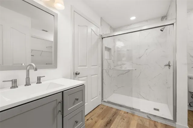 a bathroom with a double vanity sink a mirror and a bathtub