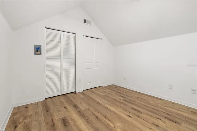 an empty room with wooden floor