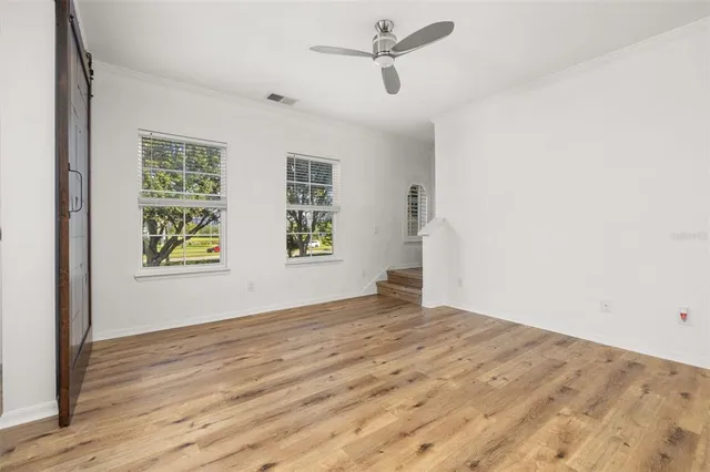 wooden floor in an empty room with a window