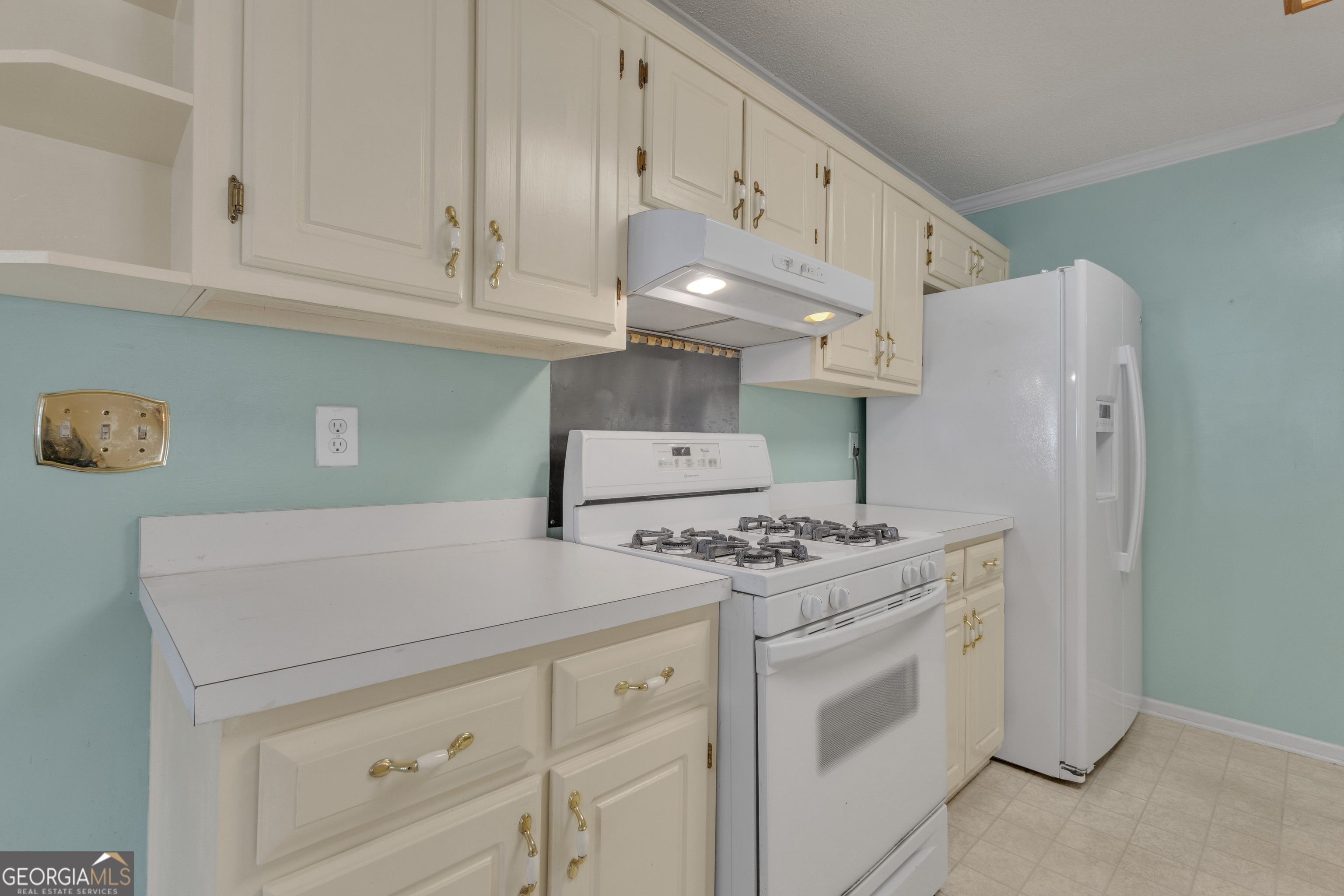 165 Masters Drive Newnan, GA 30265 - Photo 14 of 63 a kitchen with stainless steel appliances white cabinets and a stove a refrigerator with white cabinets