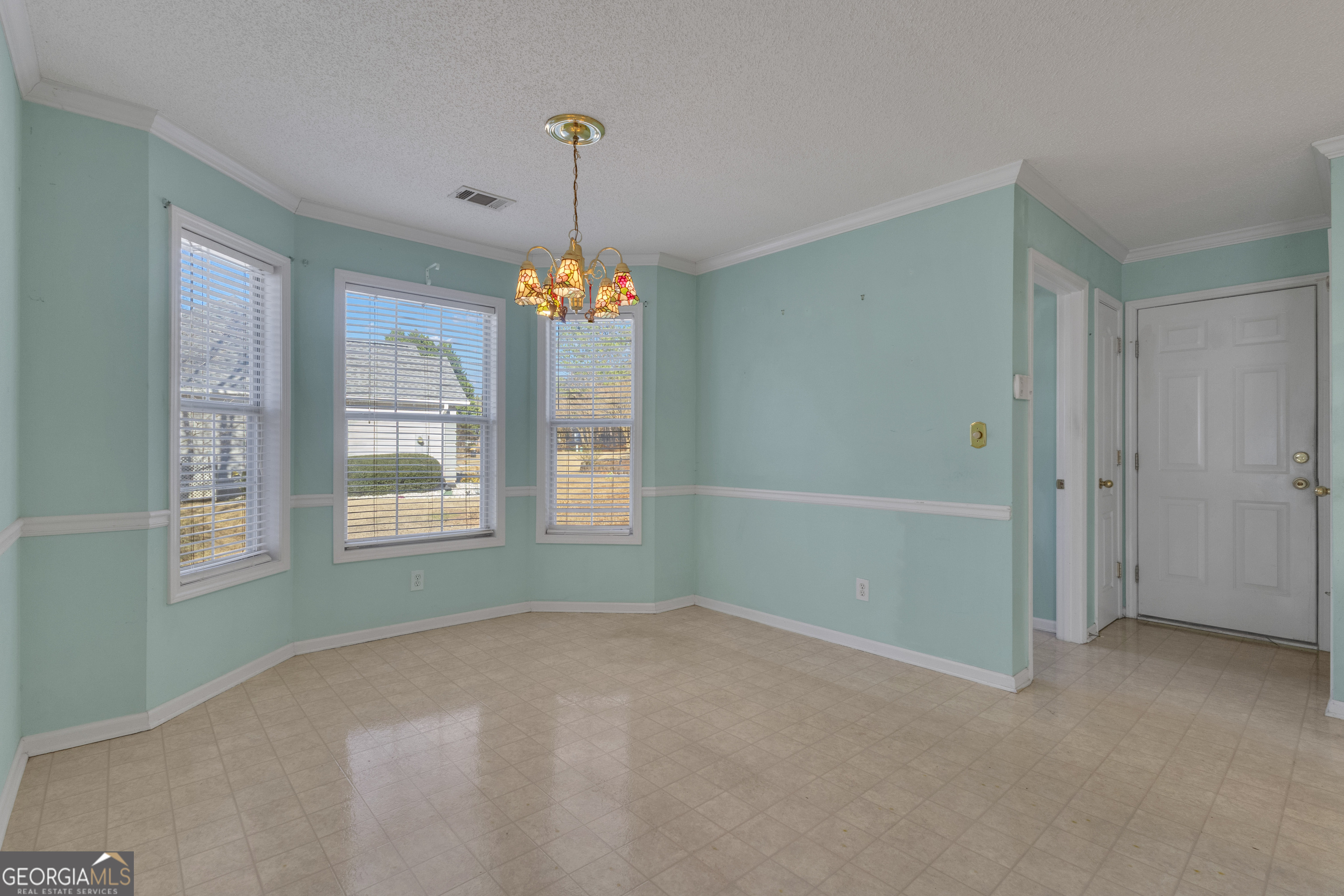 165 Masters Drive Newnan, GA 30265 - Photo 19 of 63 a view of an empty room with chandelier fan and fire place