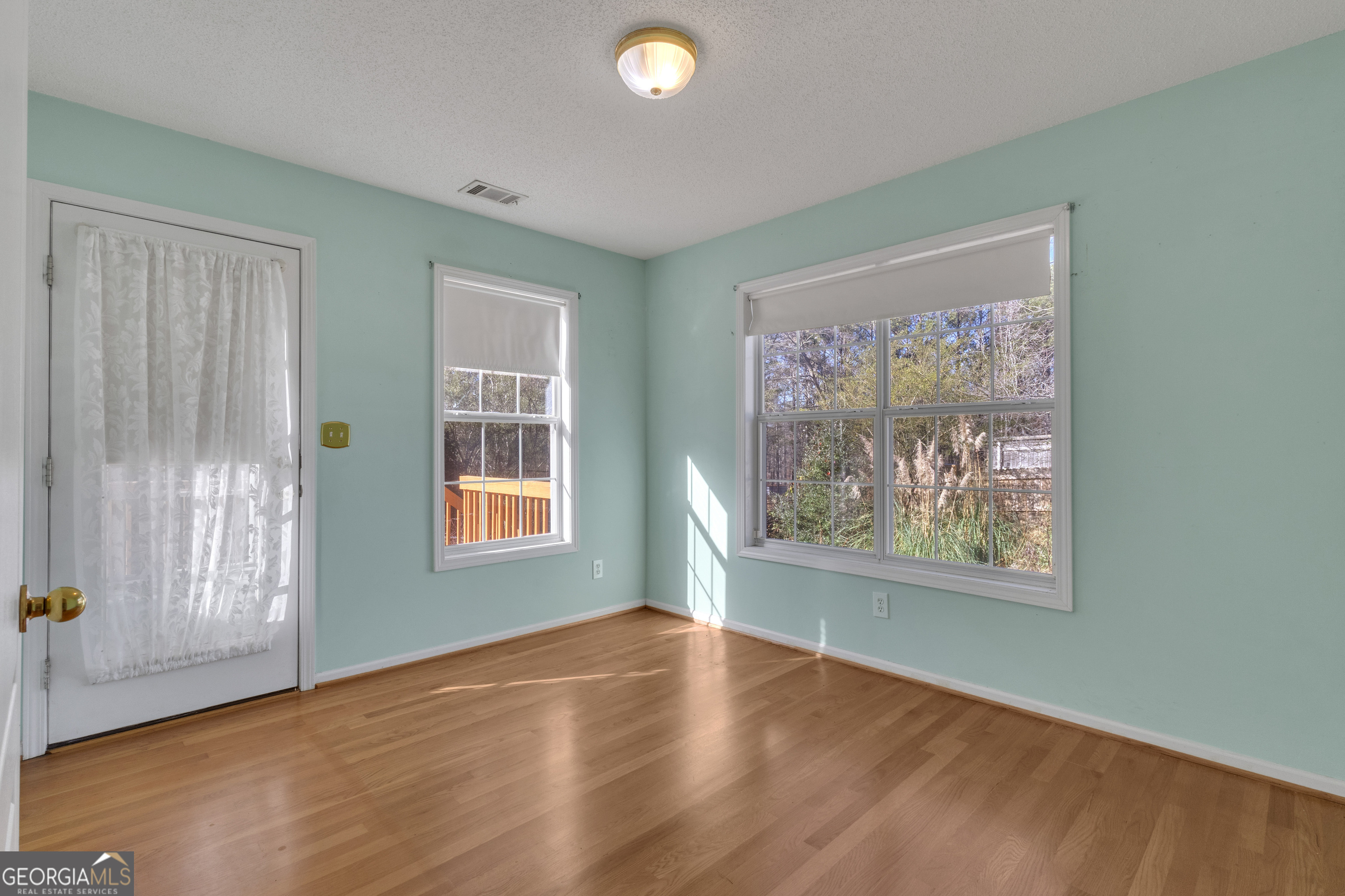 165 Masters Drive Newnan, GA 30265 - Photo 21 of 63 a view of an empty room with wooden floor and a window