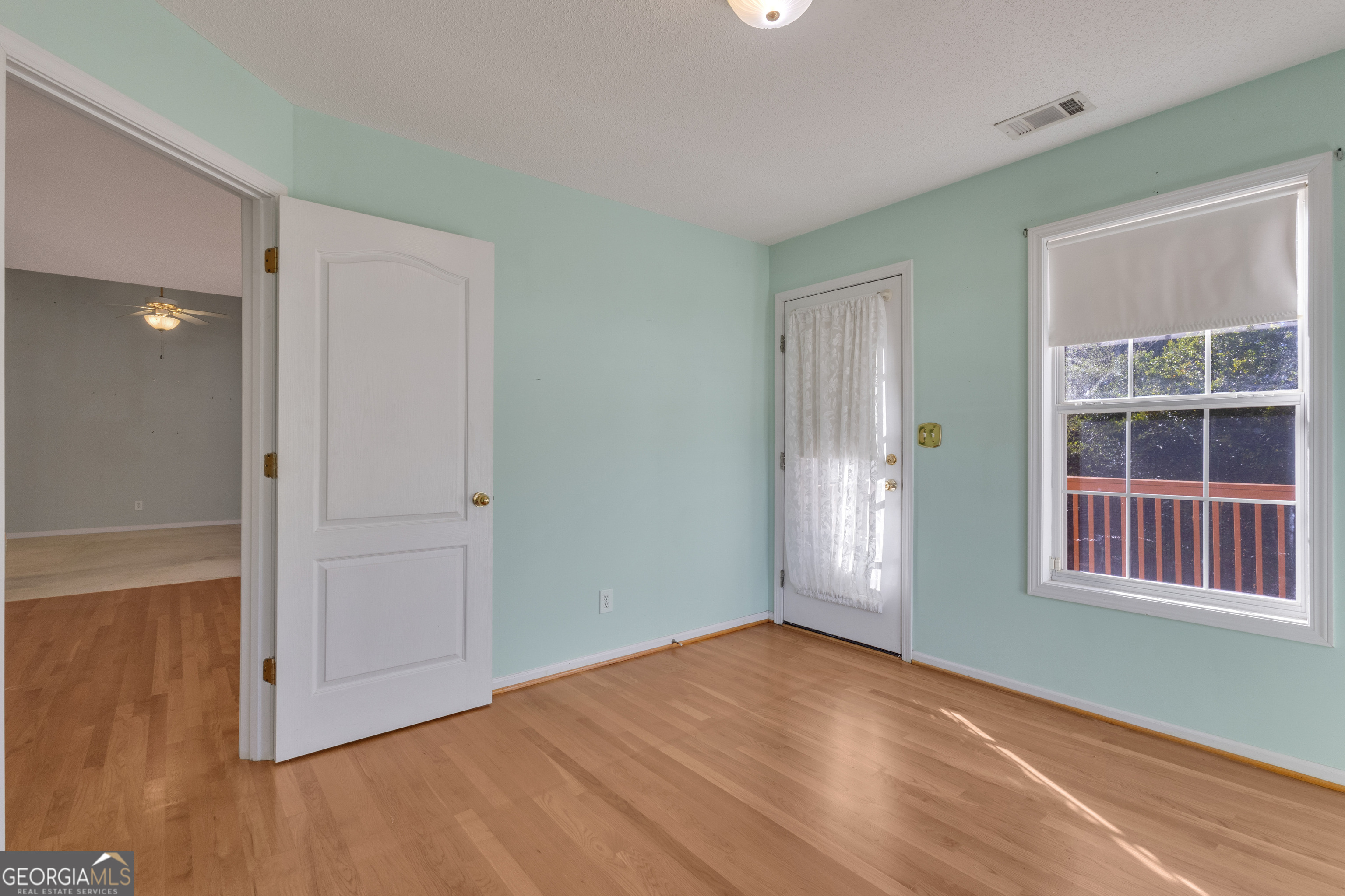165 Masters Drive Newnan, GA 30265 - Photo 22 of 63 an empty room with wooden floor and windows