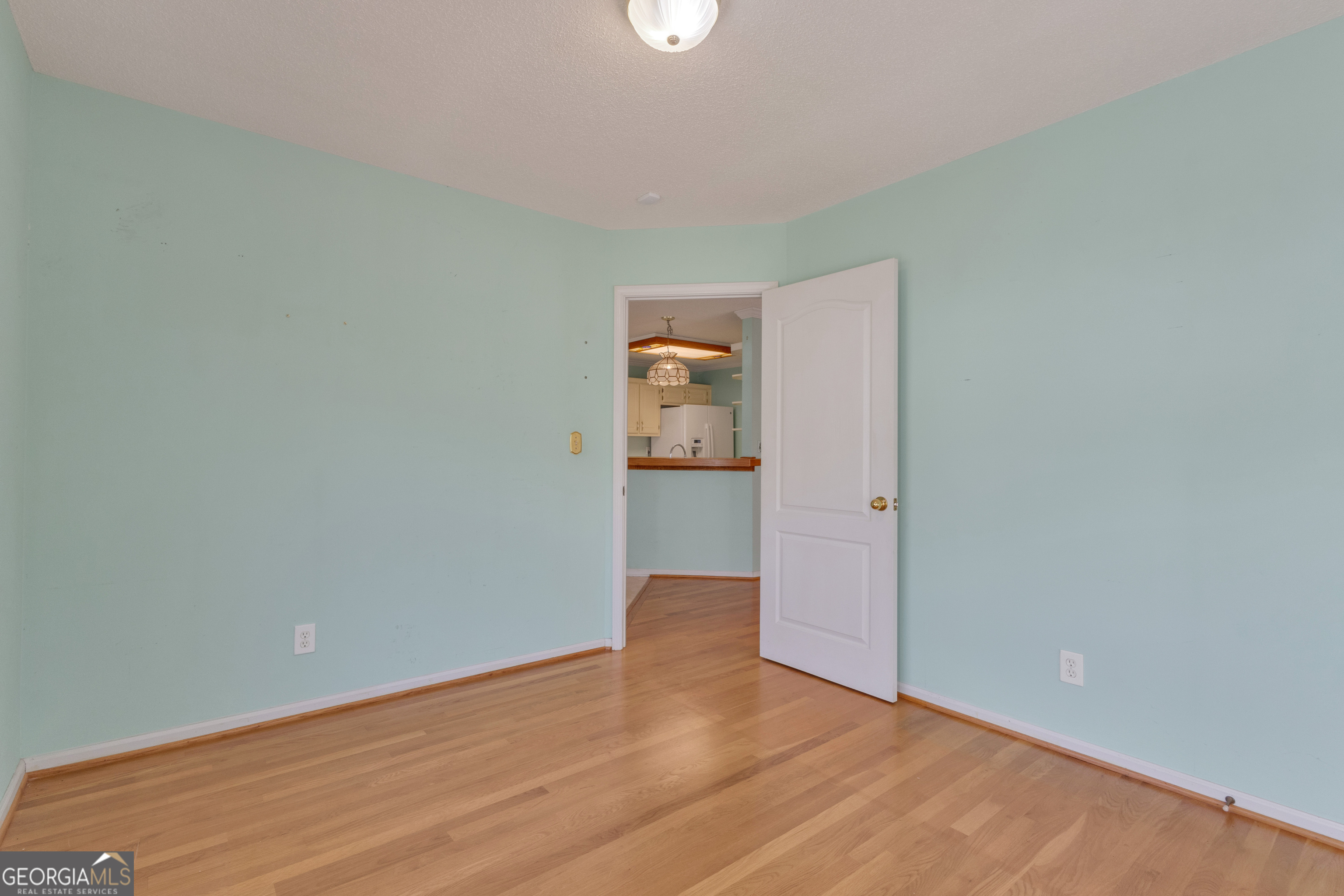 165 Masters Drive Newnan, GA 30265 - Photo 23 of 63 a view of an empty room with wooden floor and a window