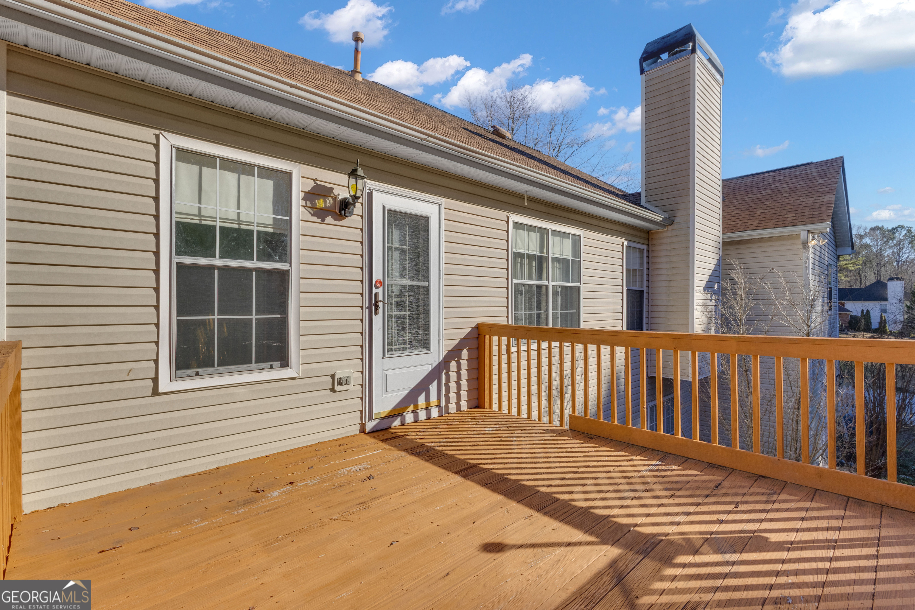 165 Masters Drive Newnan, GA 30265 - Photo 26 of 63 a view of a balcony with a potted plant and wooden floor