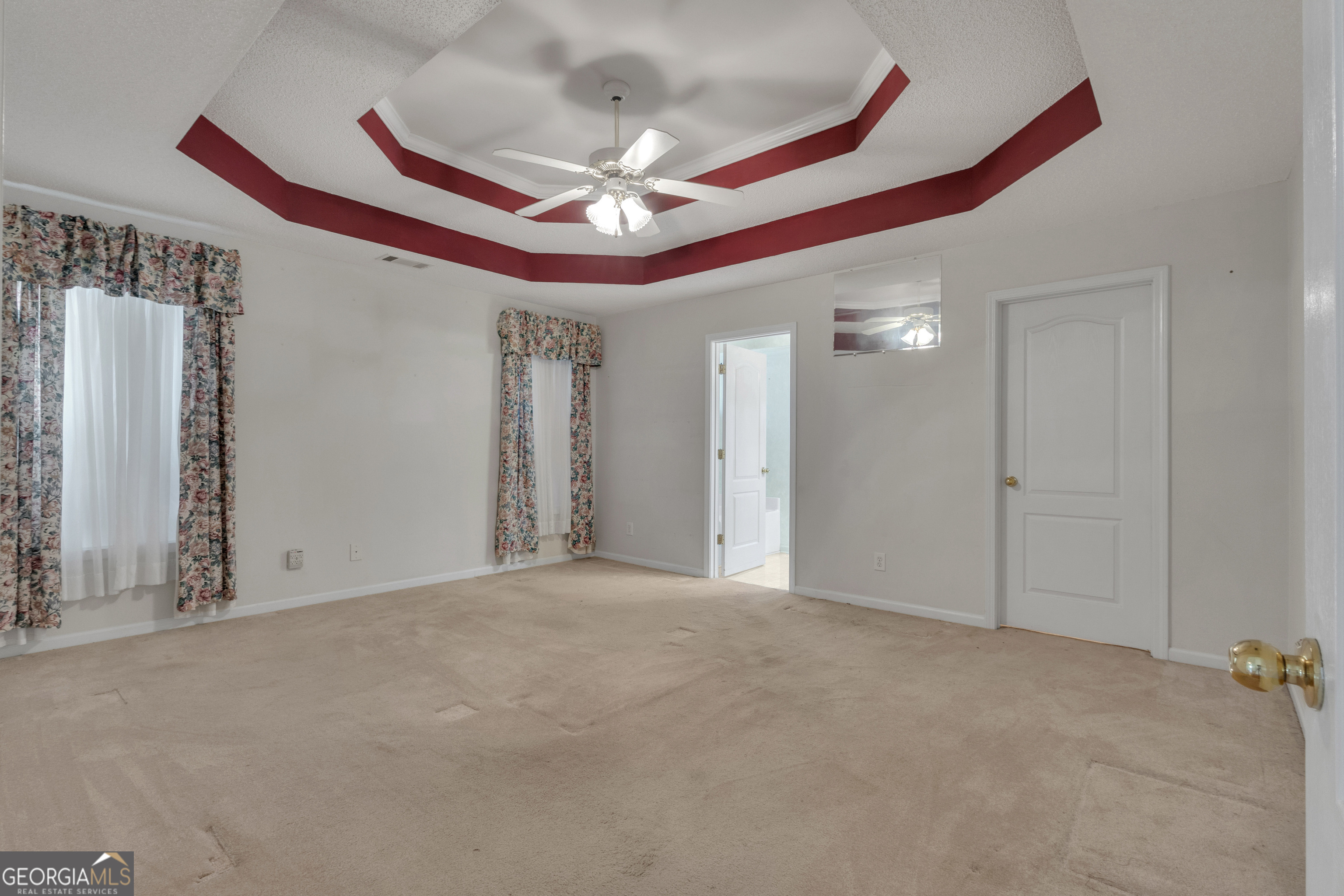 165 Masters Drive Newnan, GA 30265 - Photo 30 of 63 a view of a livingroom with a ceiling fan and wooden floor