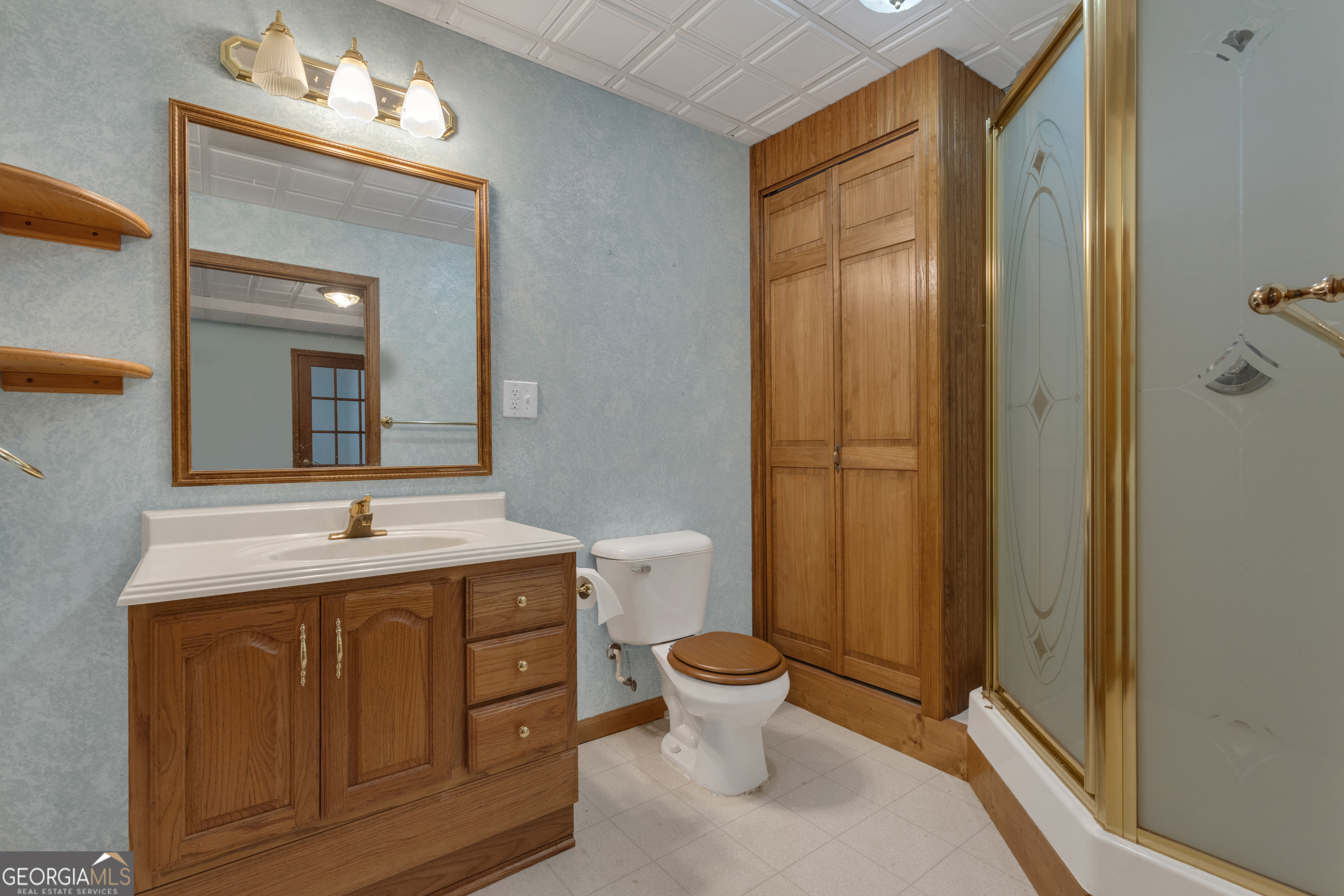 165 Masters Drive Newnan, GA 30265 - Photo 50 of 63 a bathroom with a granite countertop sink toilet and shower
