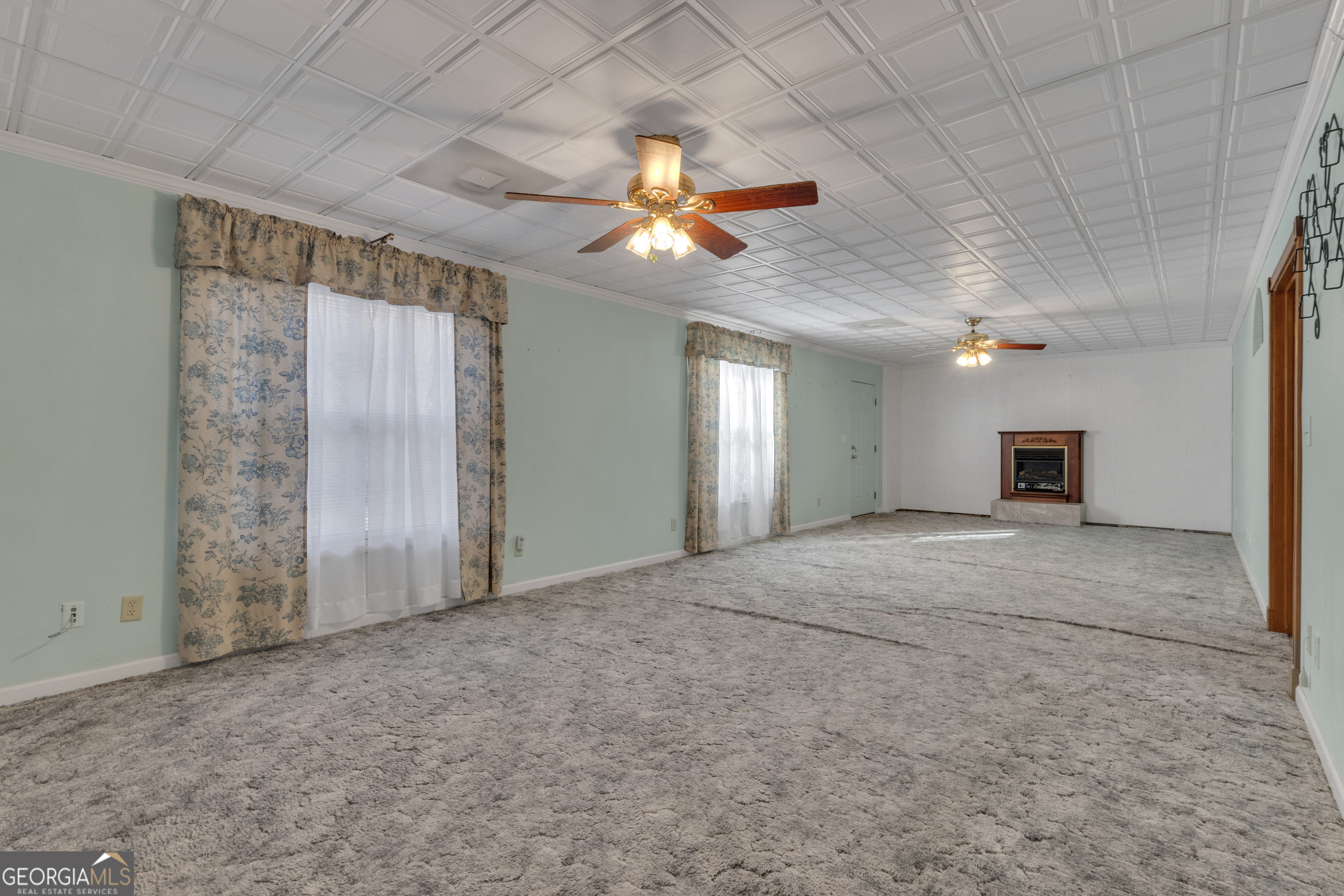 165 Masters Drive Newnan, GA 30265 - Photo 51 of 63 en empty room with windows and fan