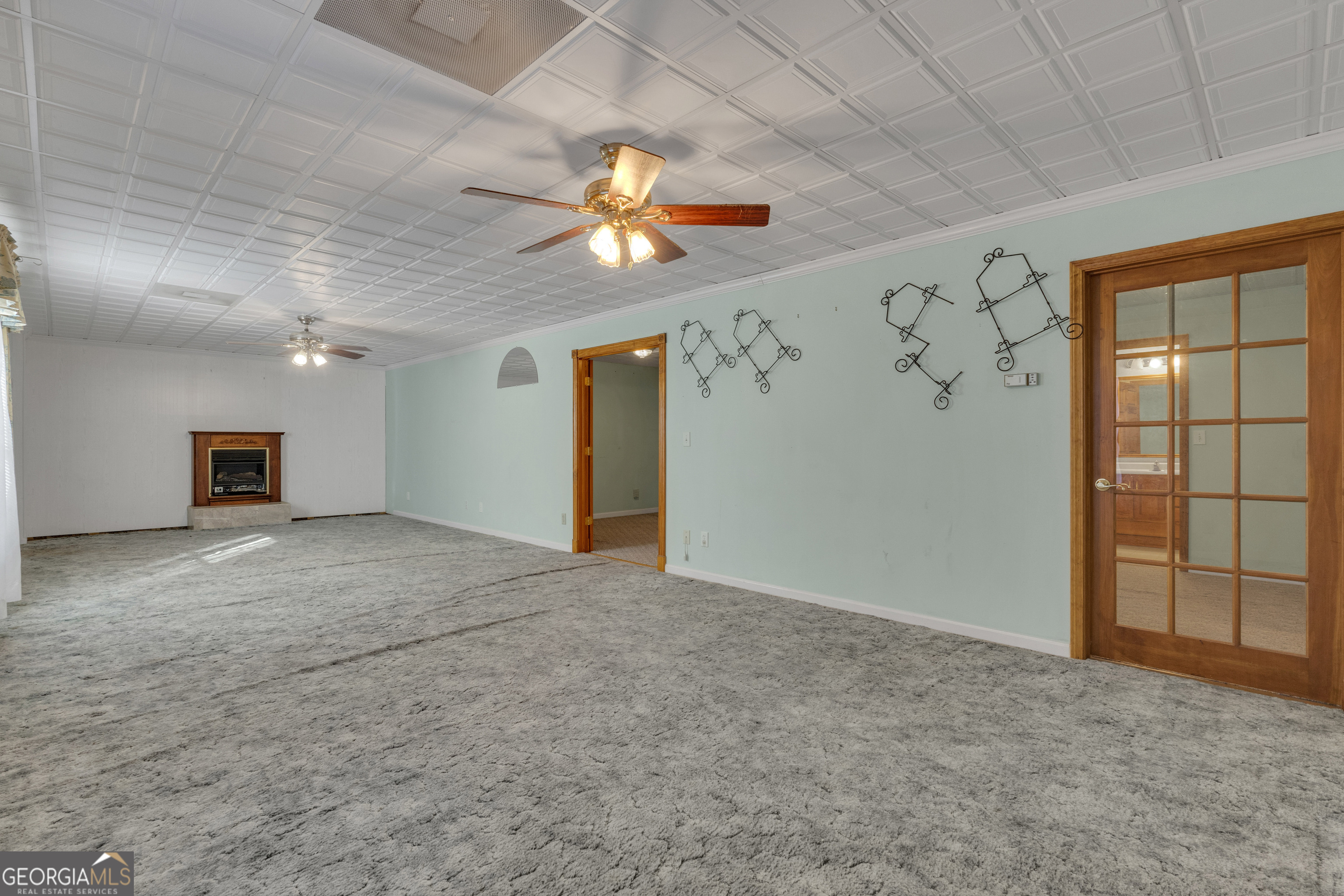 165 Masters Drive Newnan, GA 30265 - Photo 52 of 63 a view of a livingroom with a ceiling fan and window