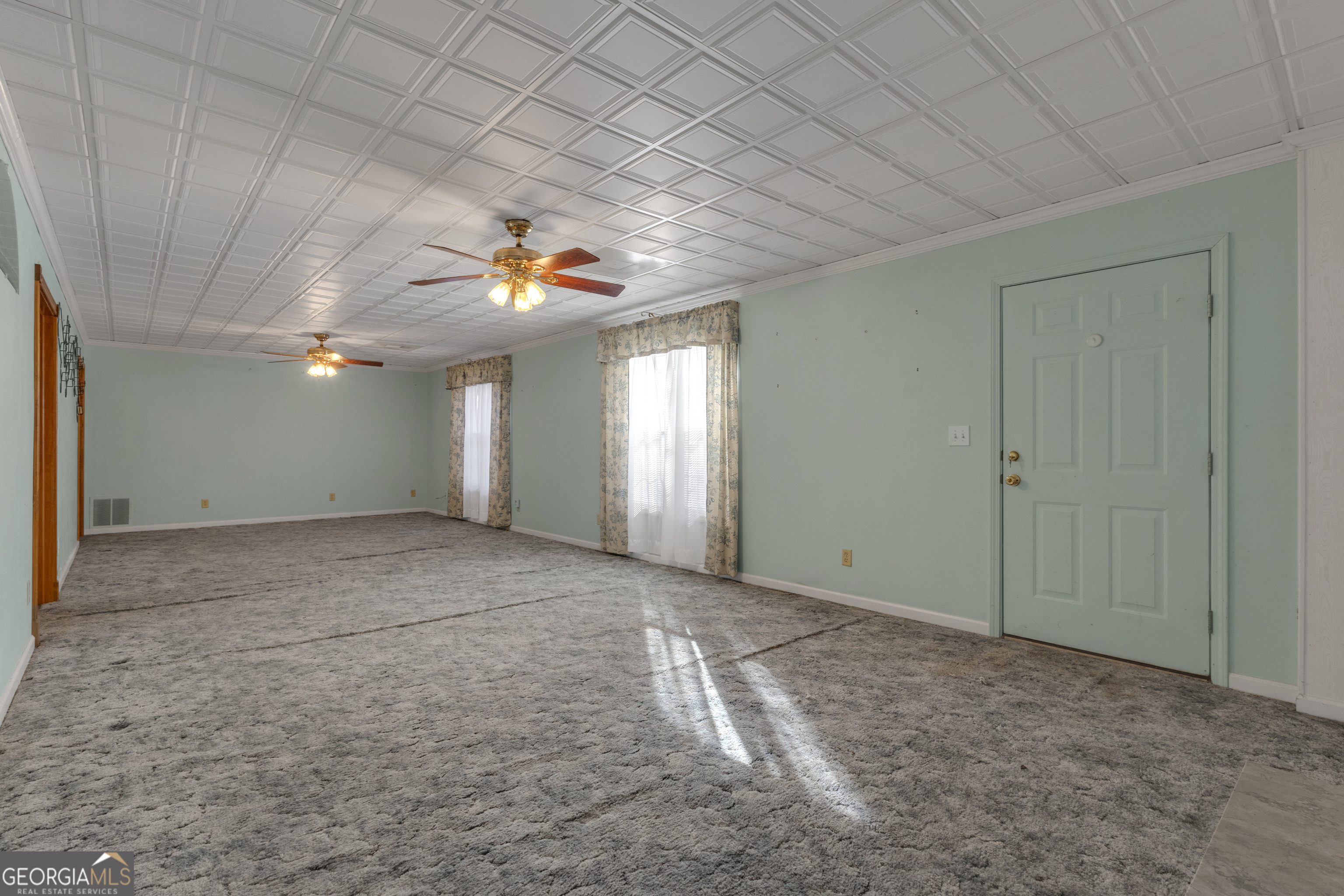 165 Masters Drive Newnan, GA 30265 - Photo 53 of 63 an empty room with a ceiling fan and window