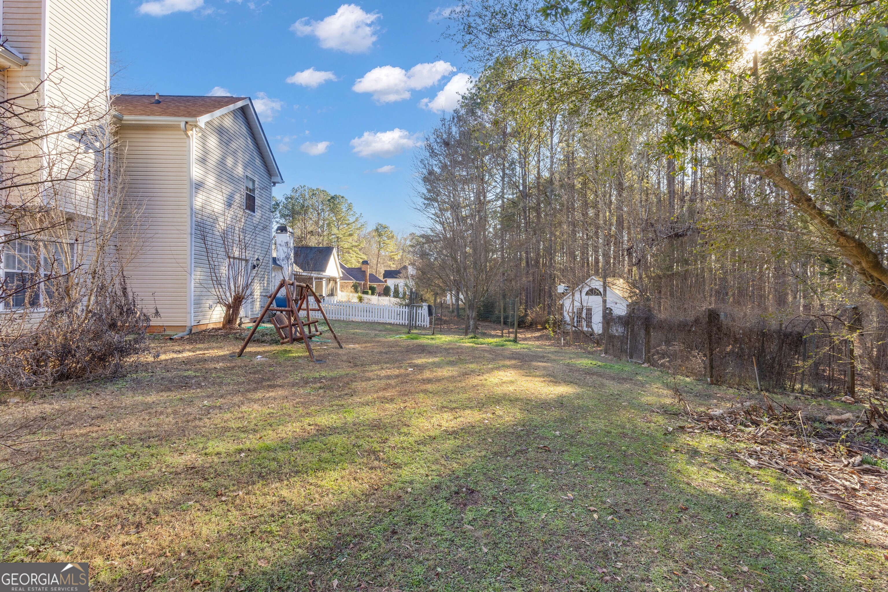 165 Masters Drive Newnan, GA 30265 - Photo 61 of 63 a view of a park with swings and slides