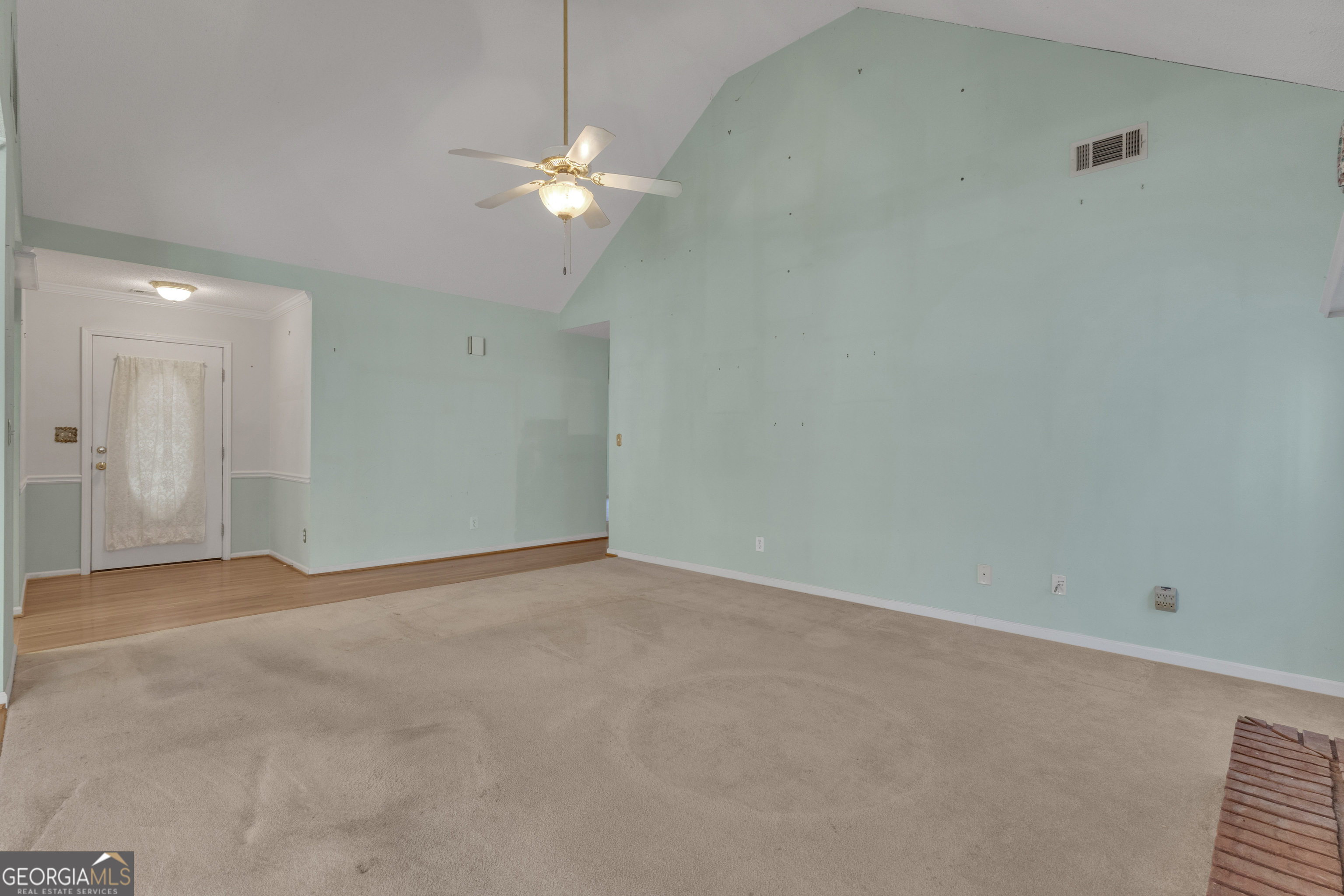165 Masters Drive Newnan, GA 30265 - Photo 10 of 63 an empty room with a chandelier fan