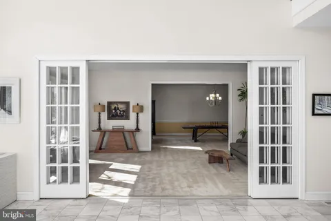 a living room with furniture and a lamp