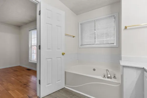 a bathroom with a bathtub and a shower