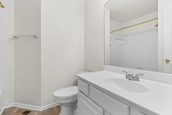 a bathroom with a sink toilet and vanity