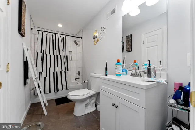 a living room with furniture a flat screen tv and a window