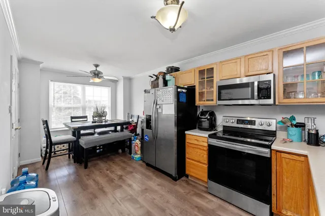 a kitchen with stainless steel appliances a stove microwave and a refrigerator