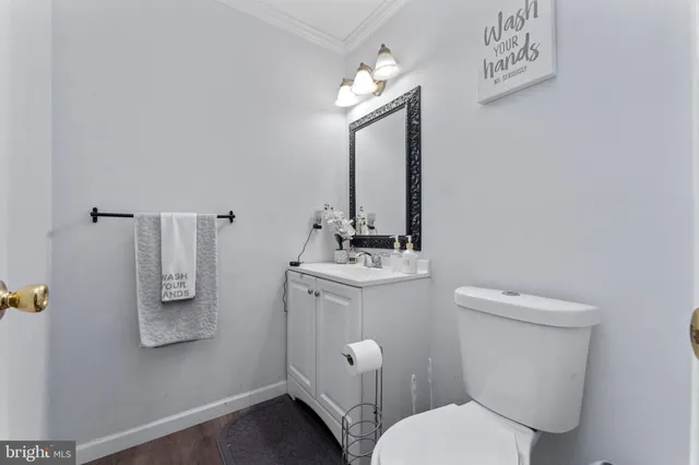 a white toilet sitting next to a bathroom sink