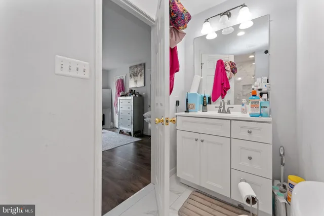 a bathroom with a sink vanity and a mirror