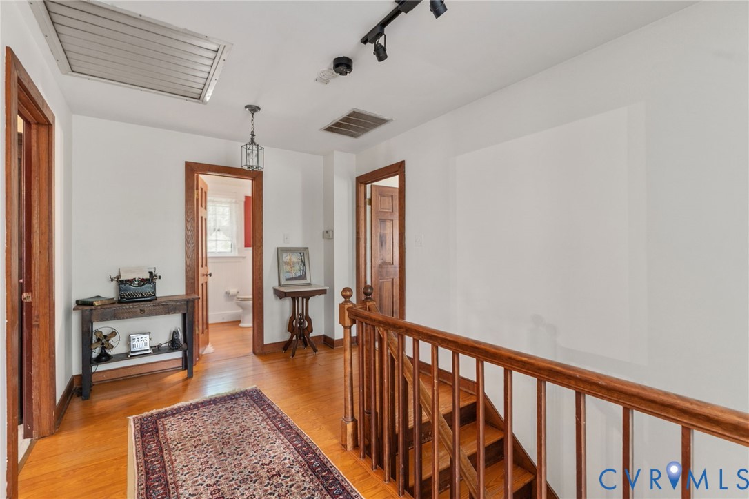7381 McClellan Road Mechanicsville, VA 23111 - Photo 40 of 66 a view of a hallway with wooden floor and a rug