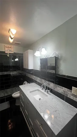 a bathroom with a sink and a mirror
