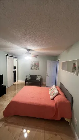 a bedroom with a bed and a television