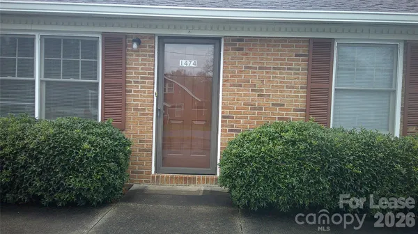a couple of potted plants in front of door