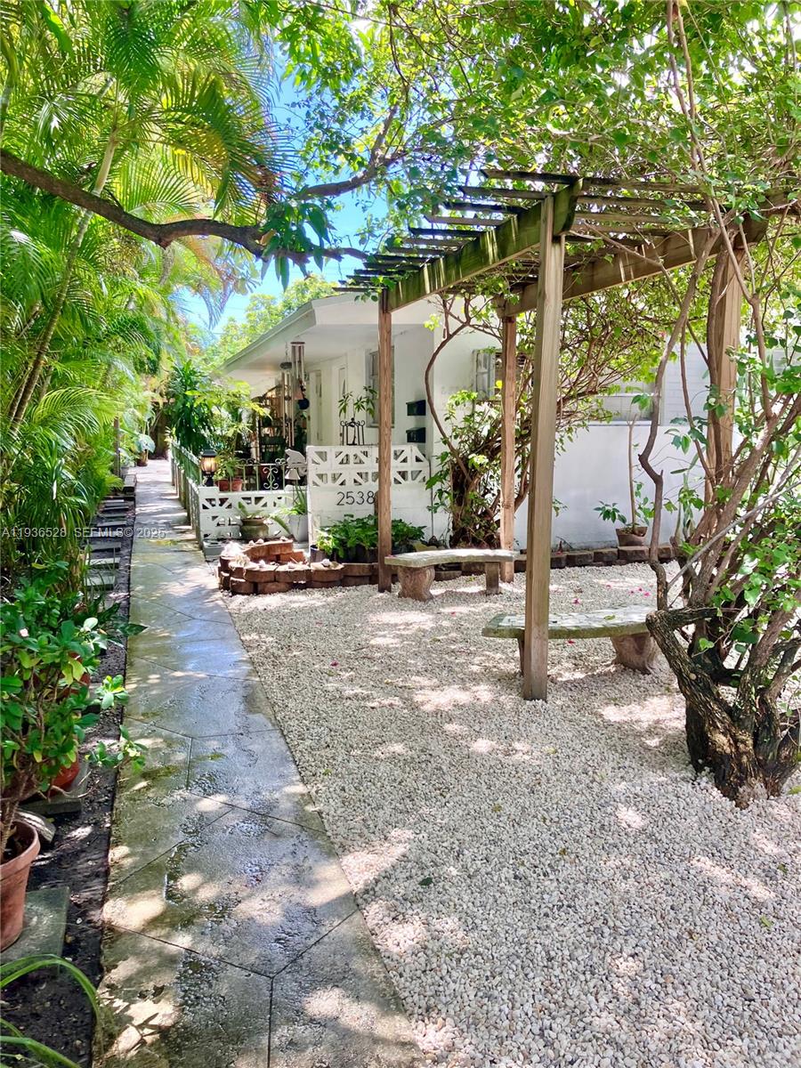 a backyard view of a house with basket ball court