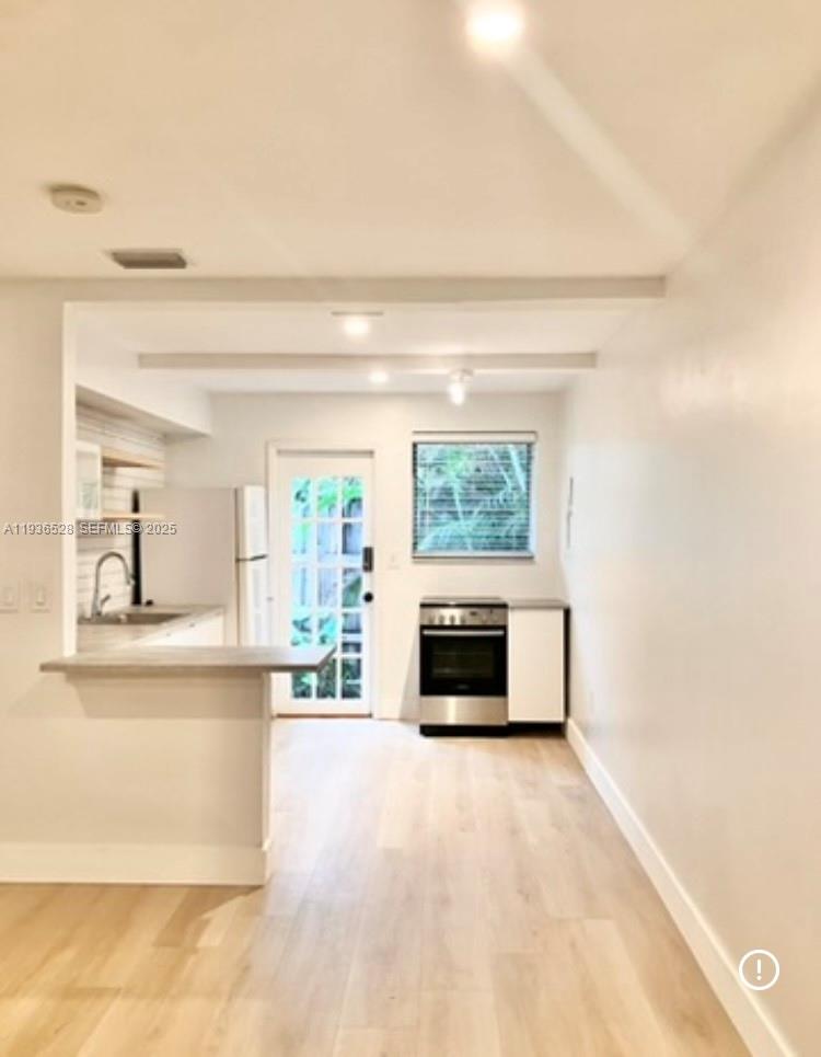 2538 Southwest 11th Street, Unit 2 Miami, FL 33135 - Photo 2 of 8 a view of a kitchen with a sink and a stove top oven