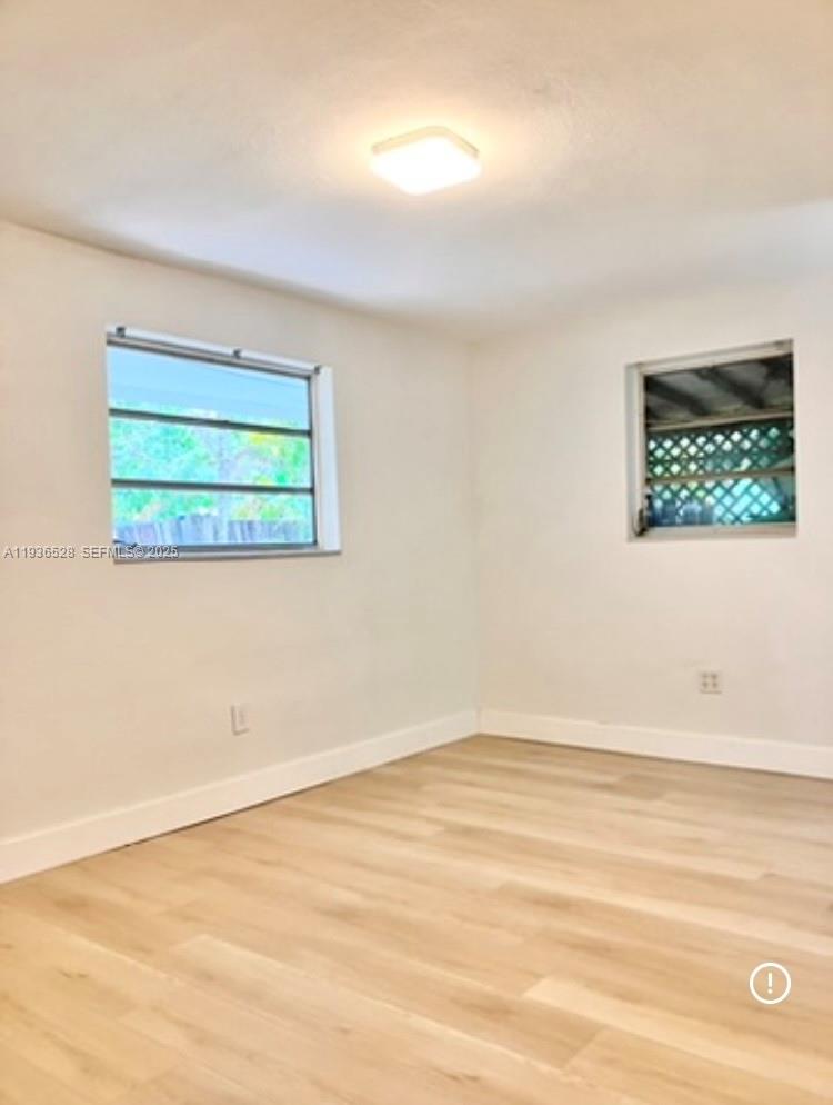 2538 Southwest 11th Street, Unit 2 Miami, FL 33135 - Photo 6 of 8 an empty room with a window
