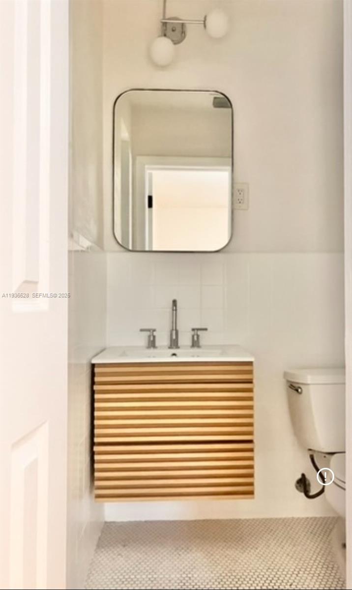 2538 Southwest 11th Street, Unit 2 Miami, FL 33135 - Photo 7 of 8 a bathroom with a sink a mirror and bathtub