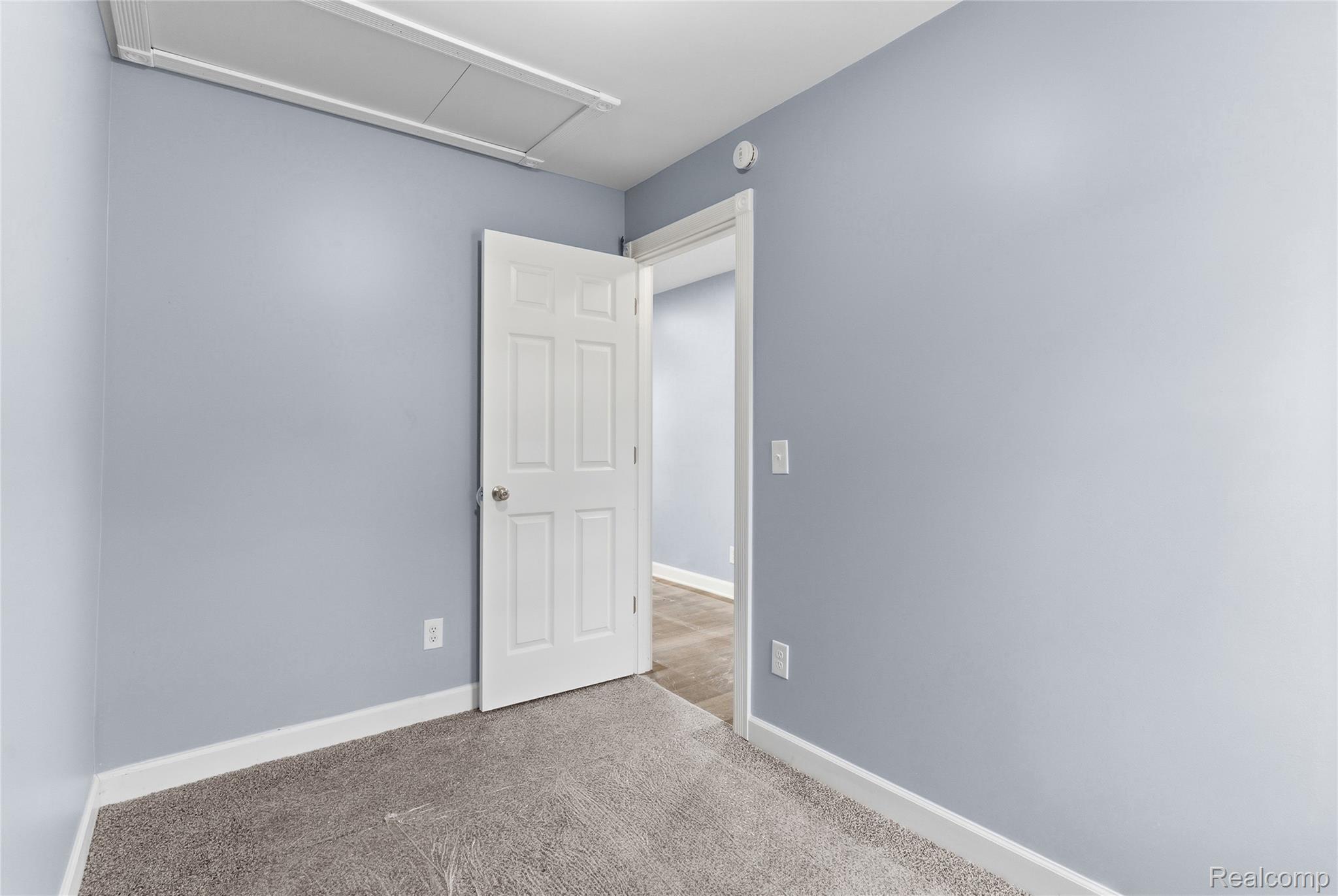3241 East Frances Road Clio, MI 48420 - Photo 19 of 32 Interior room featuring light blue walls, gray carpet, and white trim
