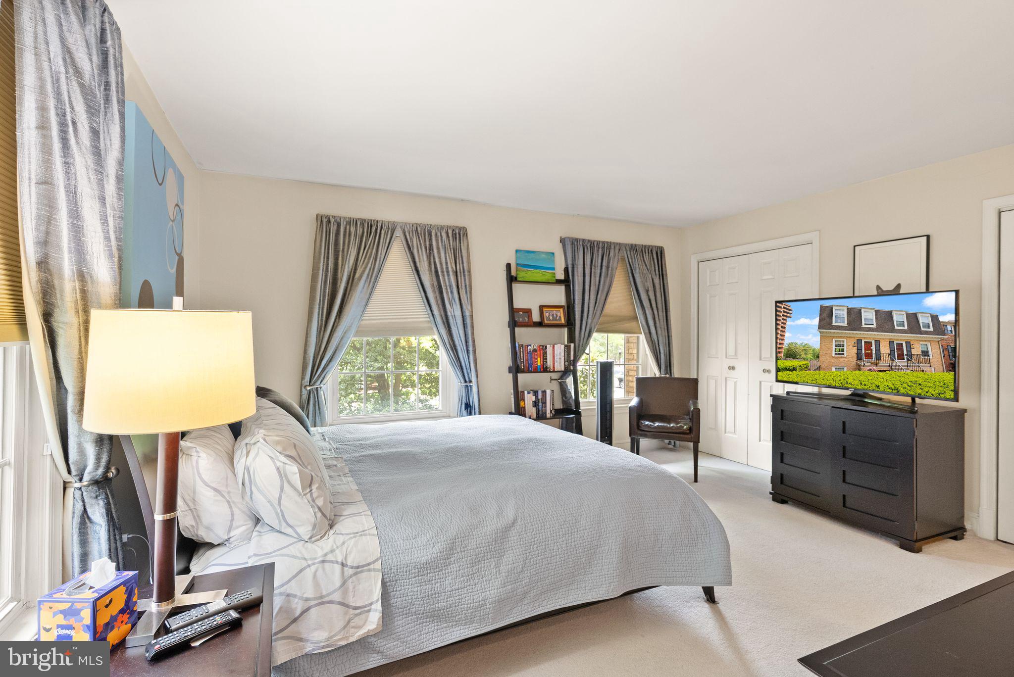 3267 Sutton Place Northwest, Unit C Washington, DC 20016 - Photo 12 of 21 a bed room with a bed window and a flat tv screen