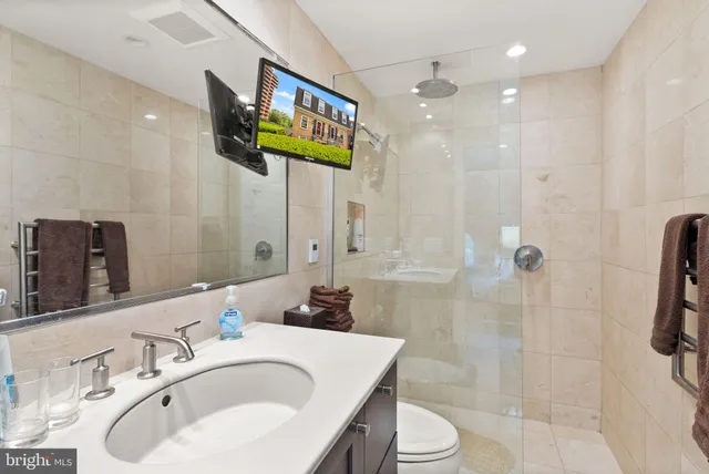 a bathroom with a sink toilet and shower