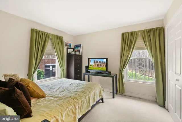 a bed sitting in a bedroom next to a window