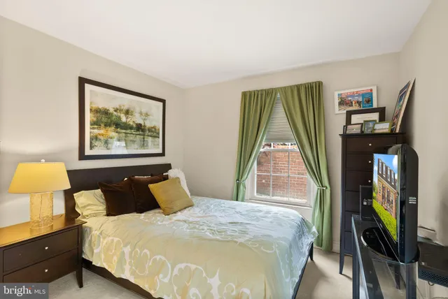 a bed sitting in a bedroom next to a window